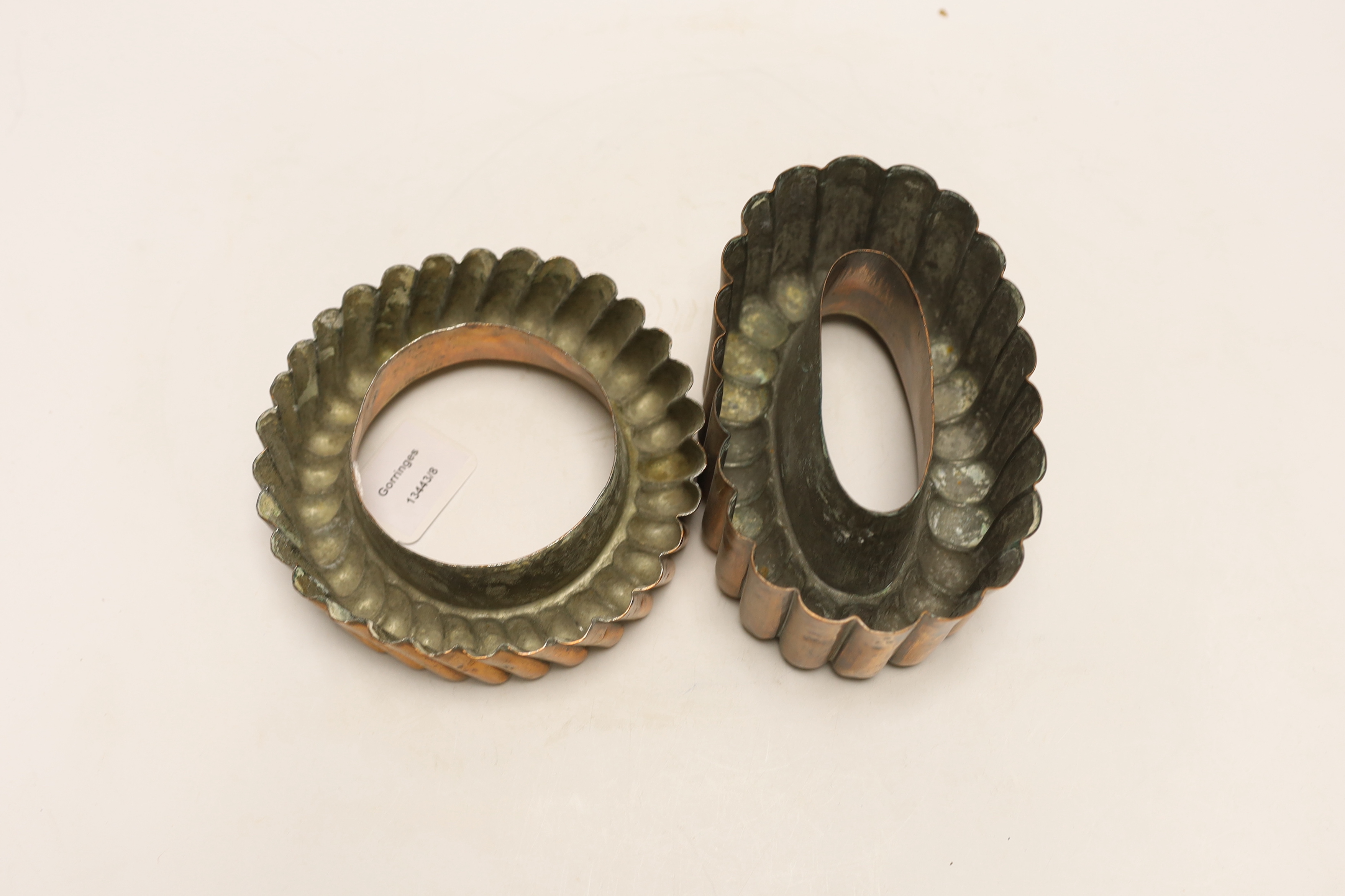 Two Victorian copper jelly moulds, the ring shaped example stamped Baileys hotel and the overall example stamped 64, largest 17cm wide